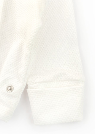 Newborn outfit: cotton gown, footed pants, and hat for the first days